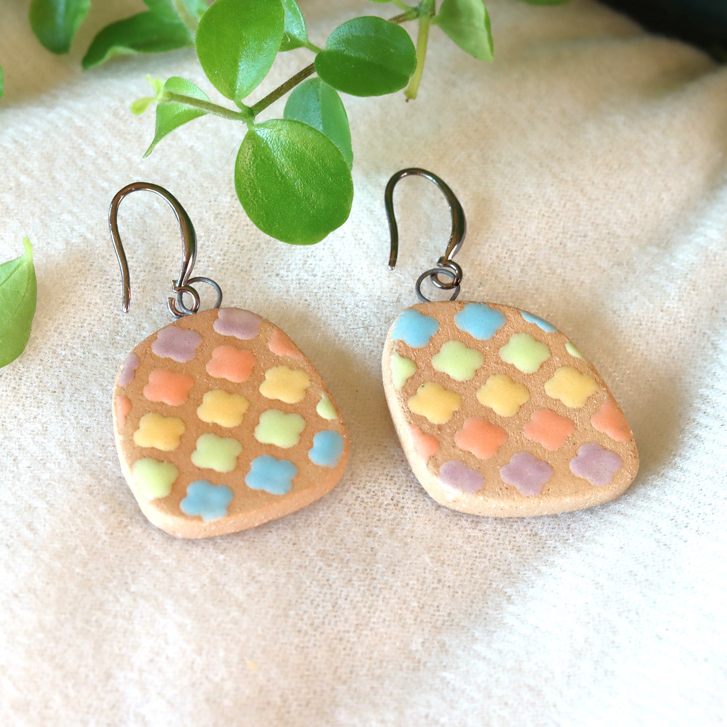 Handmade ceramic earrings with cloudy pastel pattern
