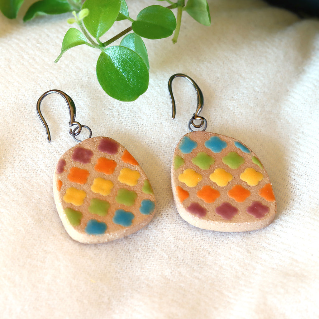 Handmade ceramic earrings with cloudy rainbow pattern