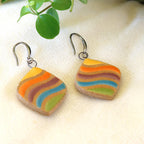 Handmade ceramic earrings with rainbow stripes