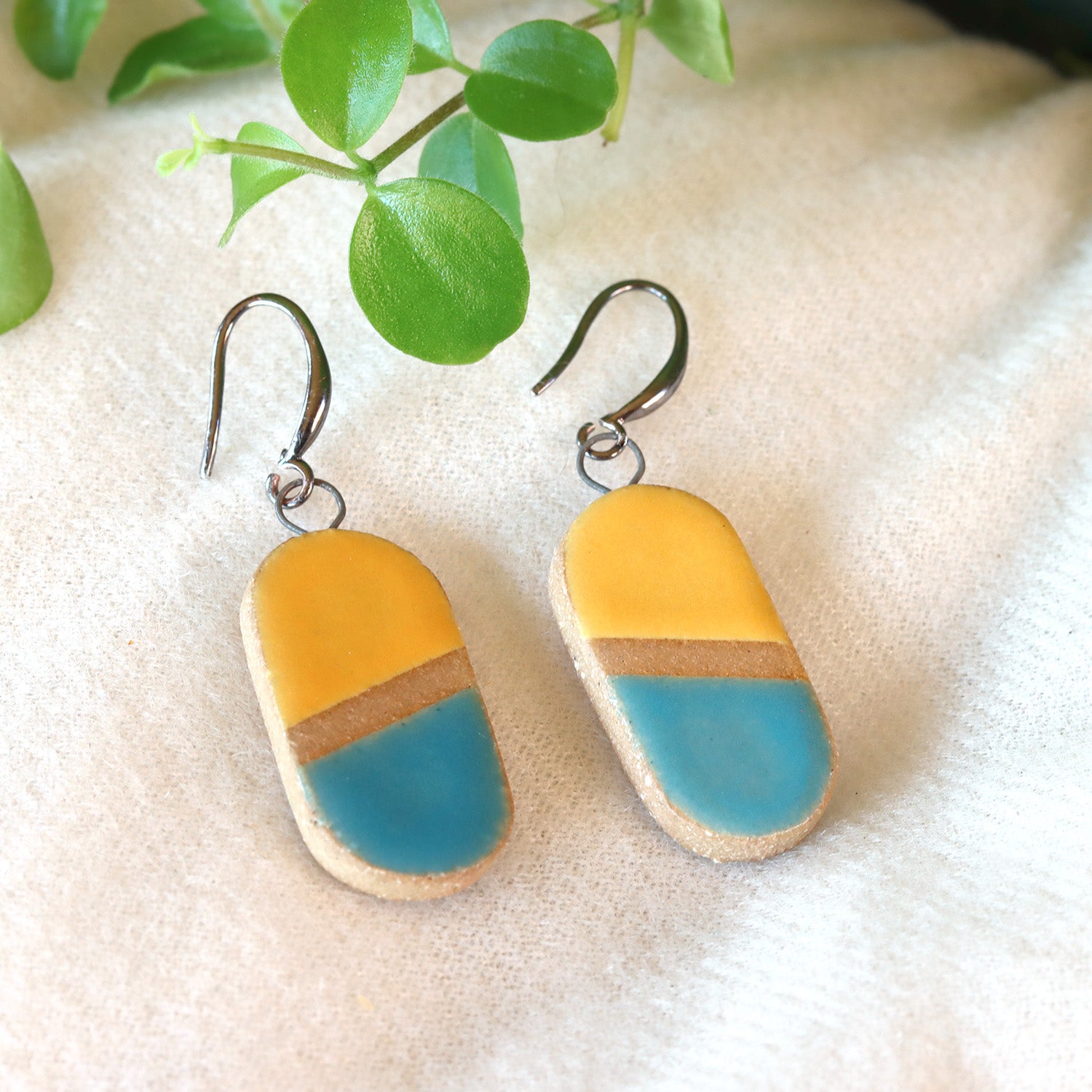 Handmade ceramic earrings in yellow and aqua