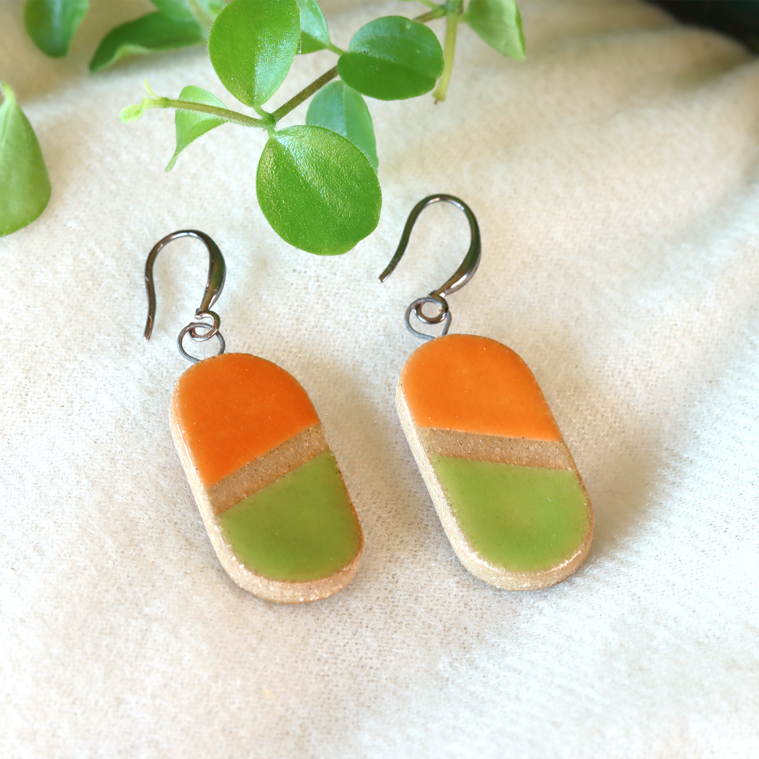 Handmade ceramic earrings in orange and lime