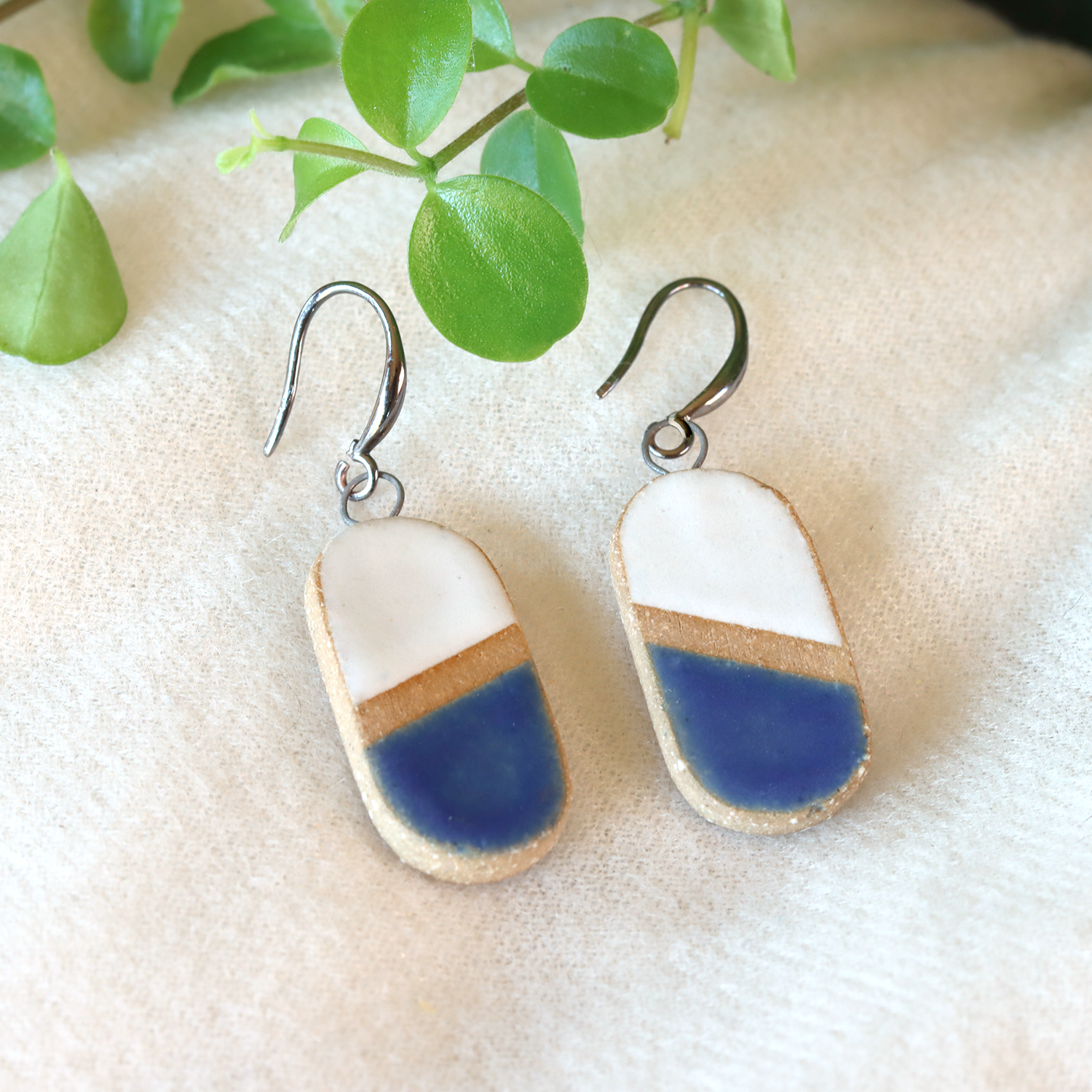 Handmade ceramic earrings in white and blue
