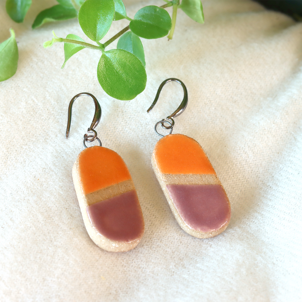 Handmade ceramic earrings in orange and purple