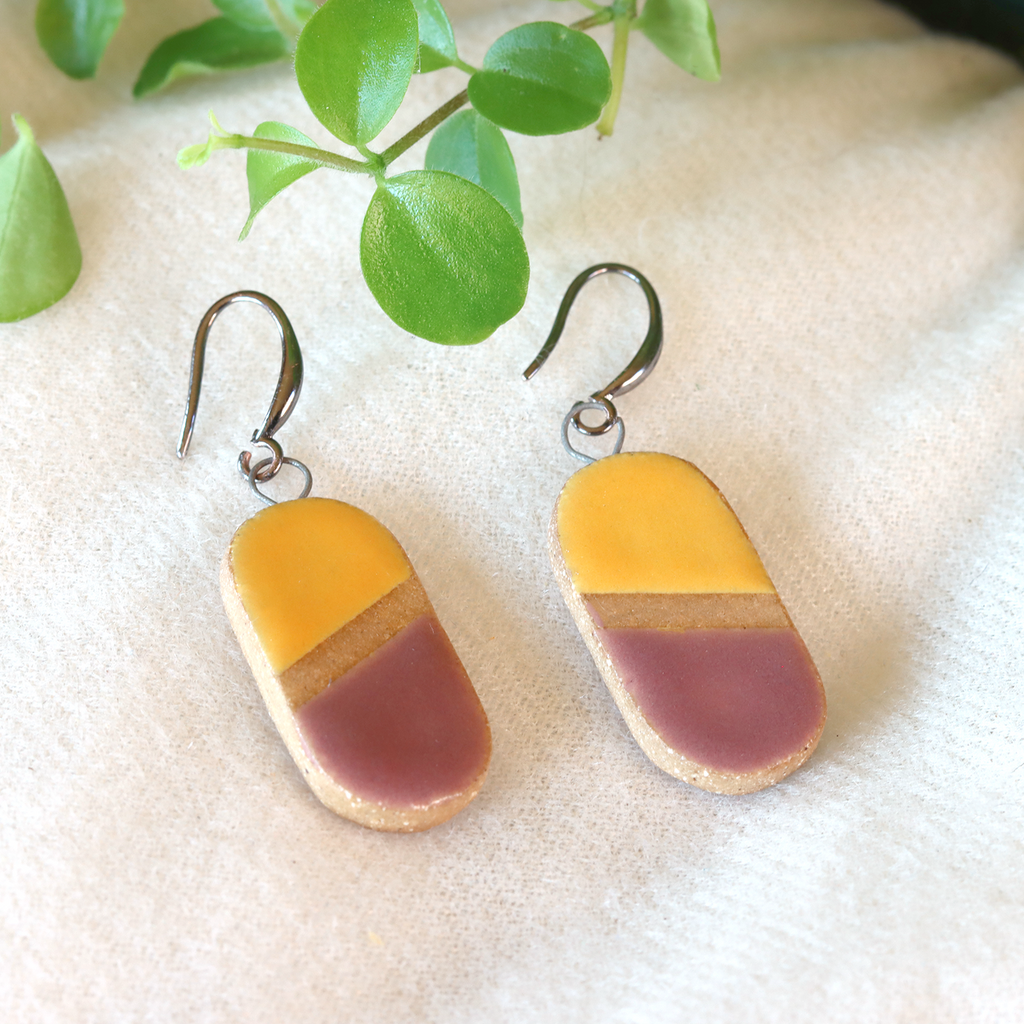 Handmade ceramic earrings in yellow and purple
