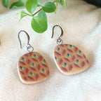 Handmade ceramic earrings with purple and green flower pattern
