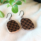 Handmade ceramic earrings with black petal pattern