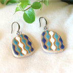 Handmade ceramic earrings with wavy blue and white pattern