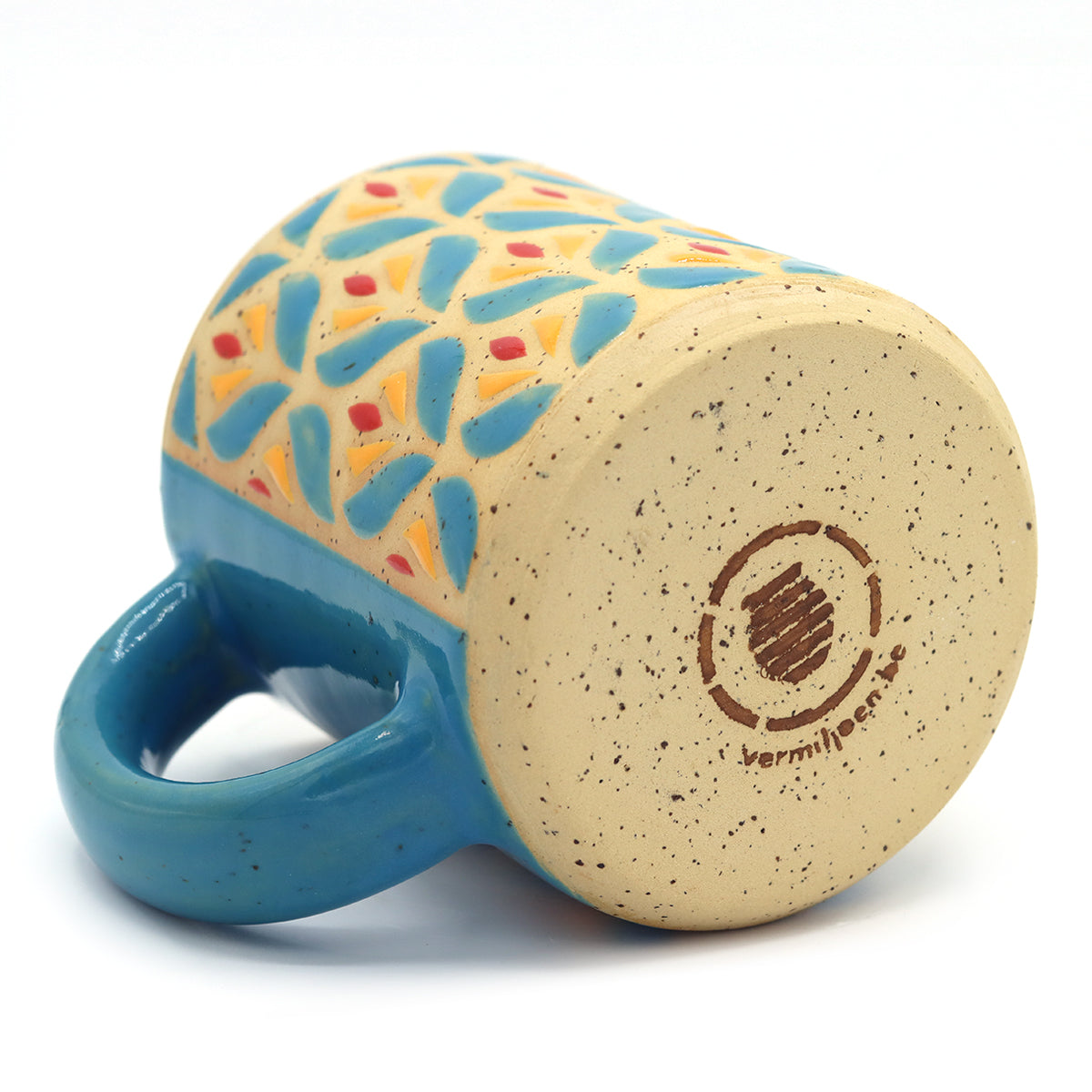 Handmade ceramic mug with blue floral pattern