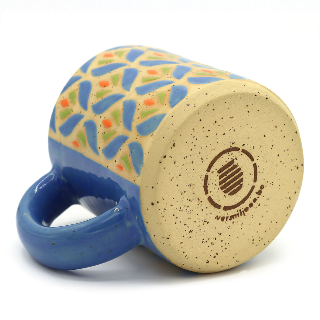 Handmade ceramic mug with blue and green floral pattern