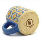Handmade ceramic mug with blue and green floral pattern