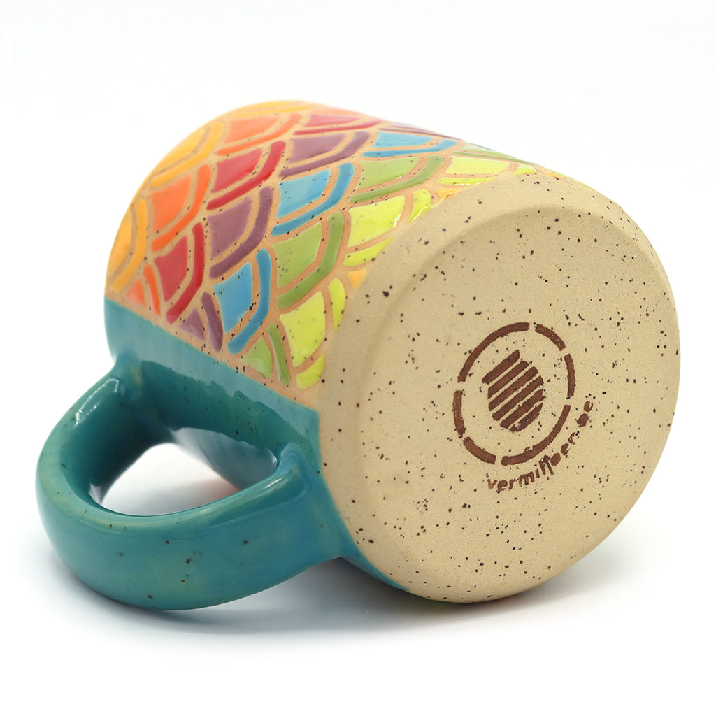 handmade ceramic mug in geometric rainbow pattern with petals