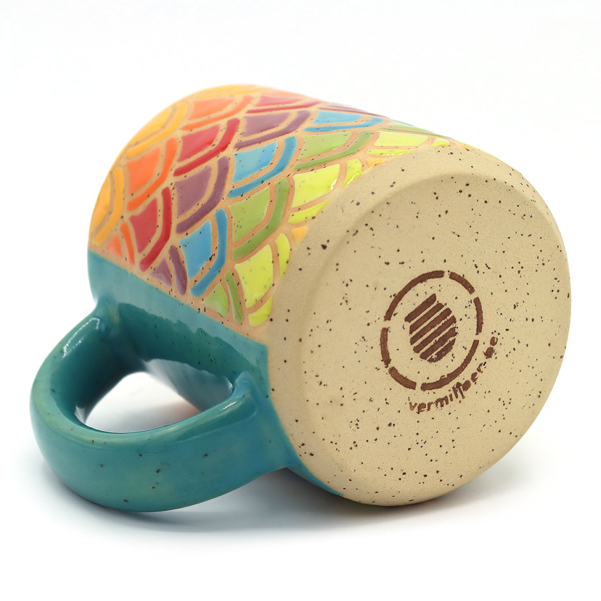 handmade ceramic mug in geometric rainbow pattern with petals