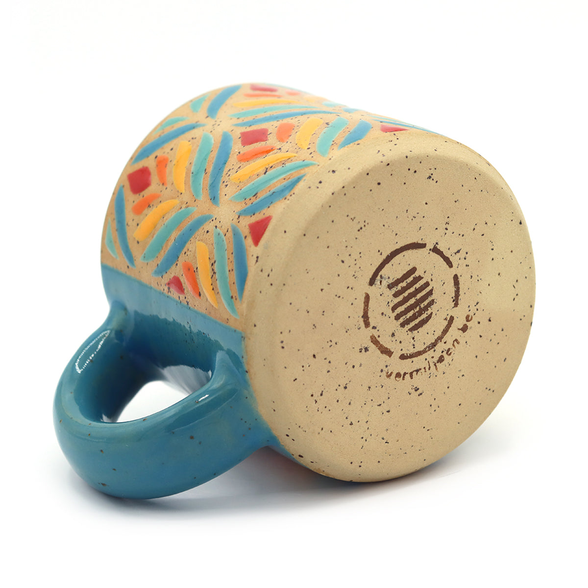 handmade ceramic mug with floral pattern in vibrant colors