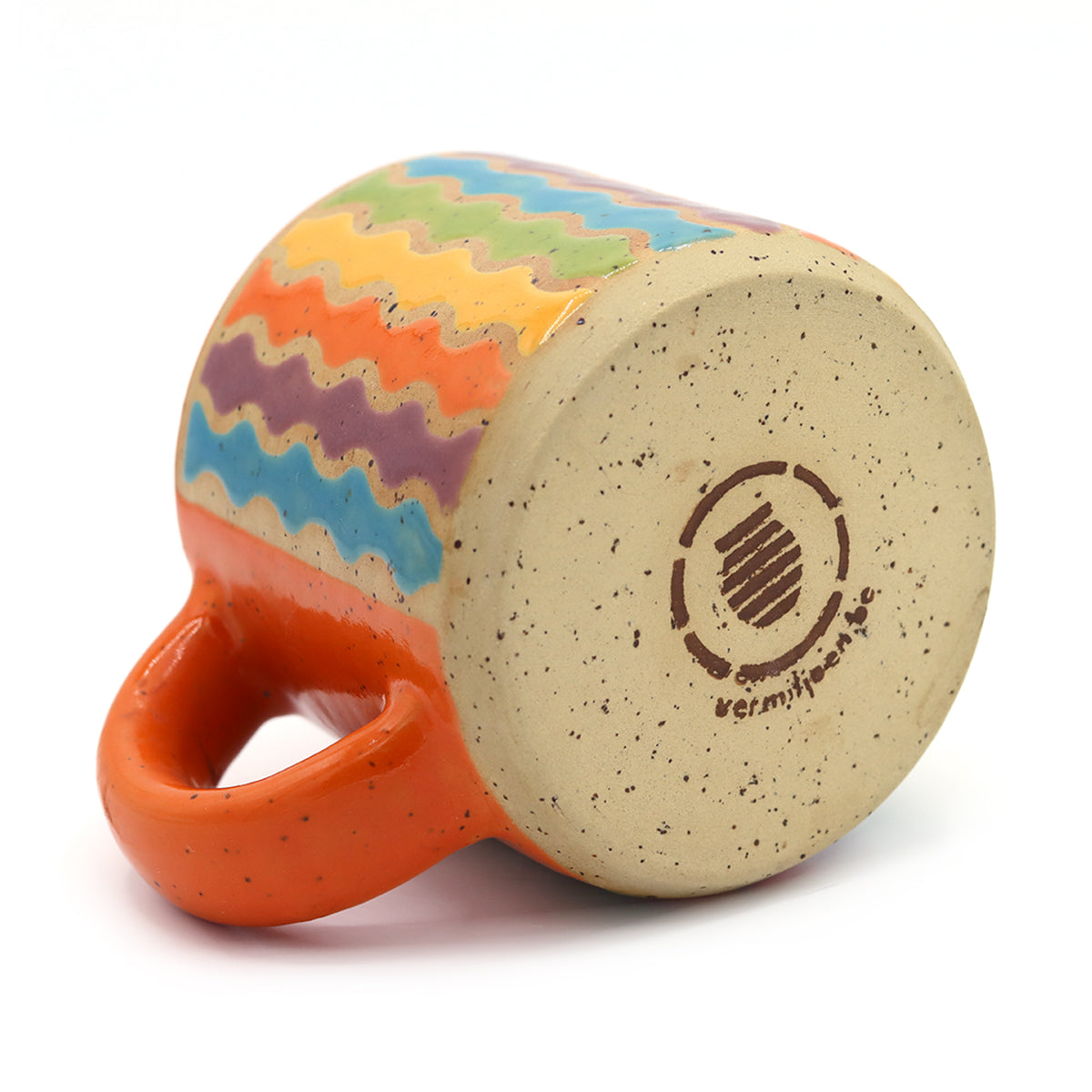 handmade ceramic mug with swirly pattern in vibrant colors