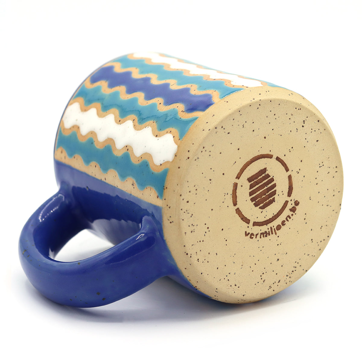 handmade ceramic mug with colourful pattern in vibrant colours