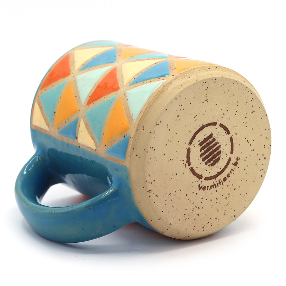 handmade ceramic mug with geometric pattern in vibrant colours