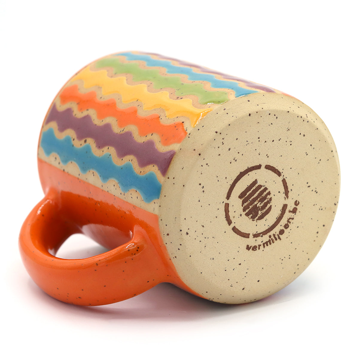 handmade ceramic mug with colourful pattern in vibrant colours