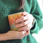 handmade stoneware coffeemug in geometric rainbow pattern with petals