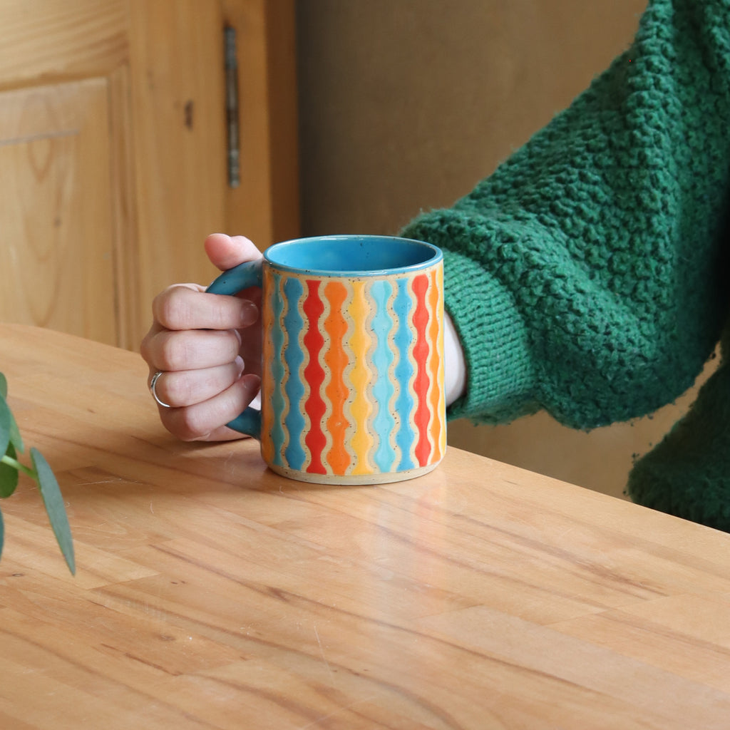 Handmade stone ware mug in vibrant colourful pattern
